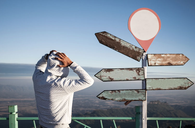 man looking at road sign - trying to discern God's will for your life