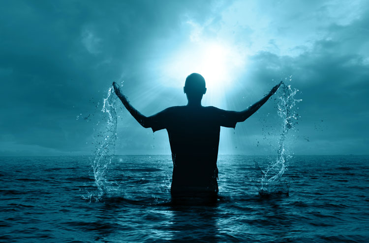 man being baptized, emerging from water