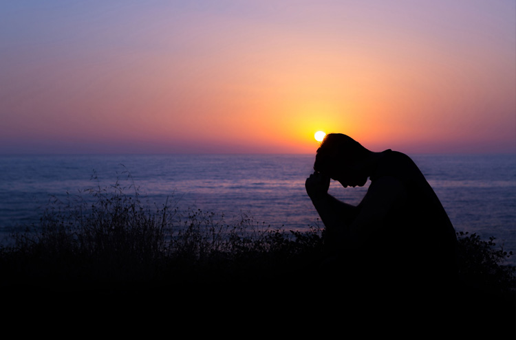 Man praying next to sunset - Have you prayed to speak in tongues but still are unable?