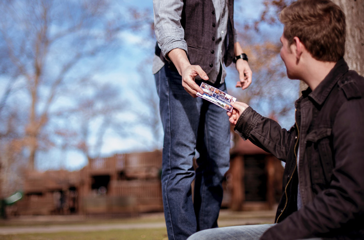 Evangelist handing out gospel tract - Should you persuade people to accept Jesus as their personal Savior?