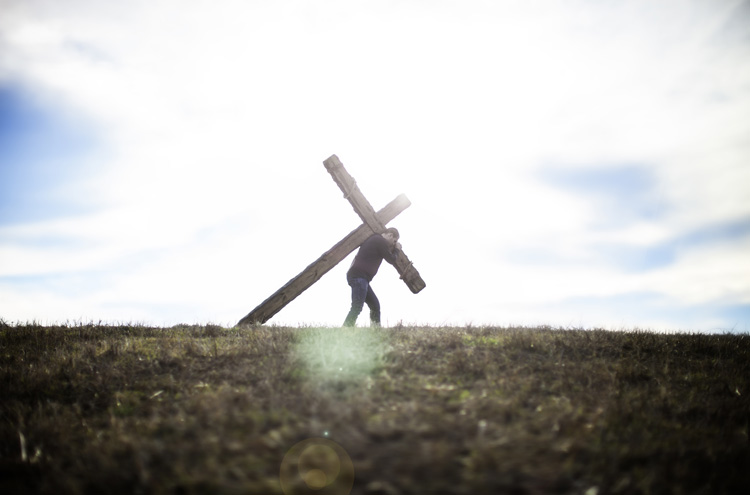 Modern day man carrying his cross - Can a true Christian stop following Jesus