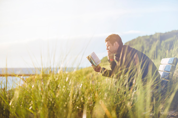 Man reading book, pondering - Is your salvation conditional or unconditional?