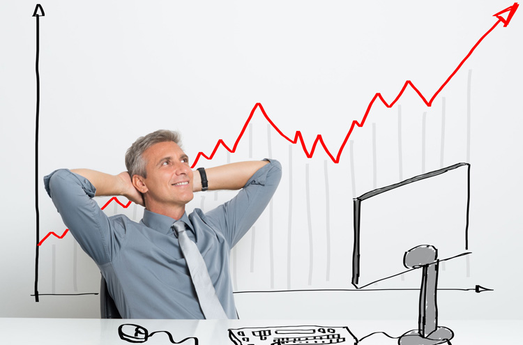 Man leaning back at computer - Is it wrong to invest in the stock market