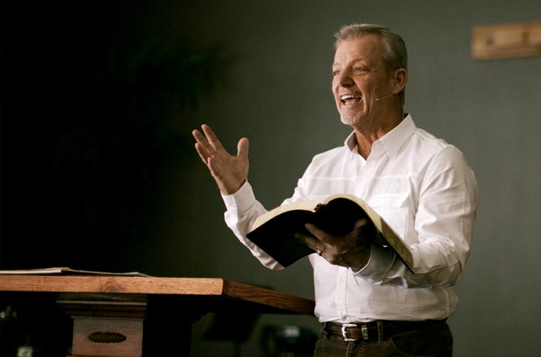 Pastor holding Bible at church, preaching - What should be the mission statement of every single church in the world?