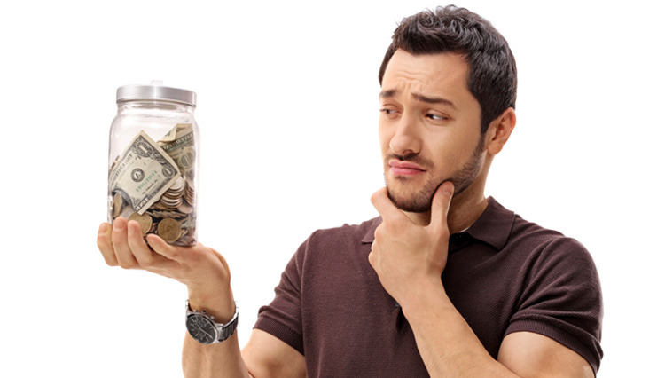 Man holding jar with money - Is it possible to be rich and righteous
