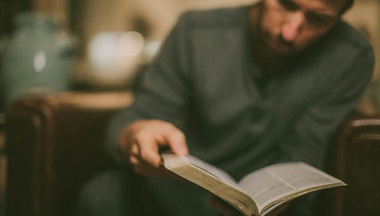 Picture of Christian man reading Old Testament in his Bible