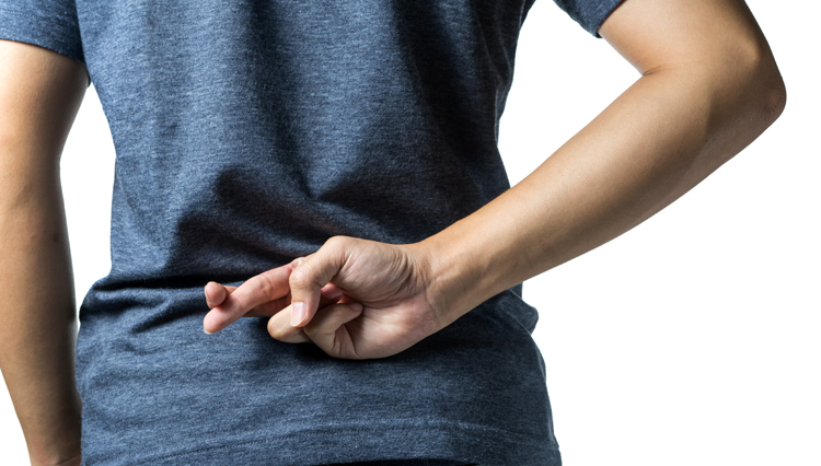 Picture of man crossing fingers, lying