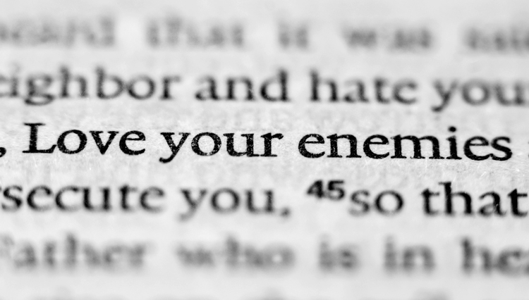 Picture of Bible opened to verse, "Love your enemies."