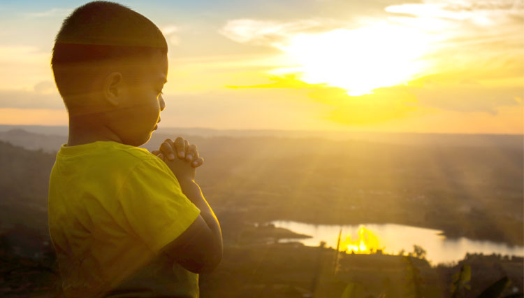 Little boy making prayer requests