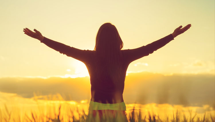 Picture of woman lifting her hands in worship