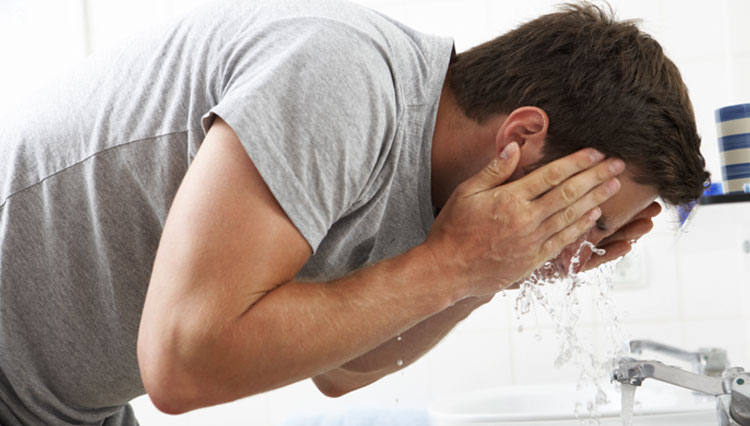 Picture of man washing his face