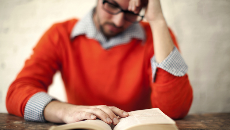 Picture of man reading Bible and thinking about forgiveness