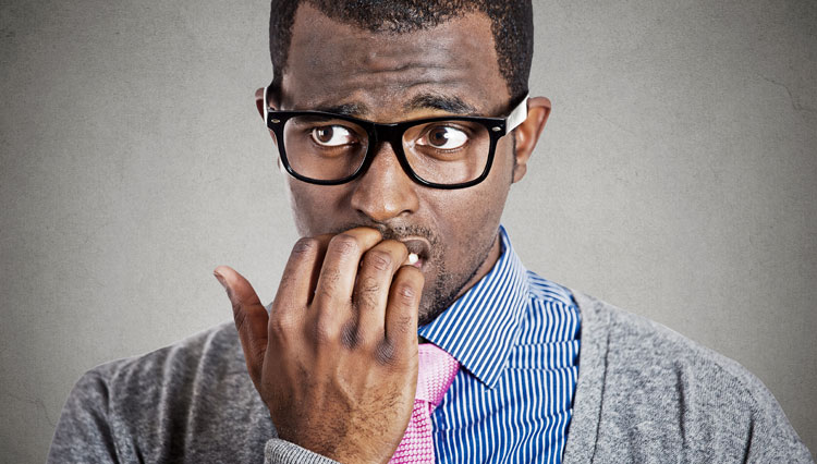 Picture of man biting his fingernails, worrying