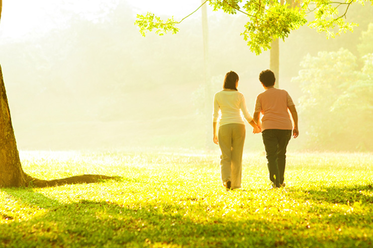 Picture of daughter walking with elderly parent