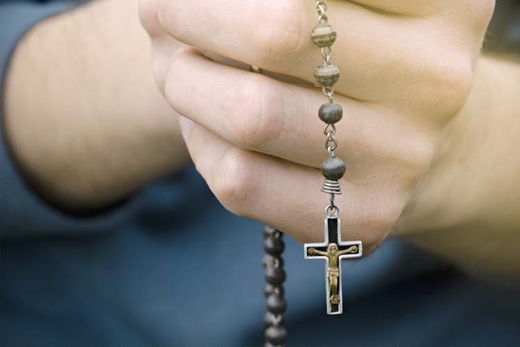 Picture of Roman Catholic Christian holding crucifix