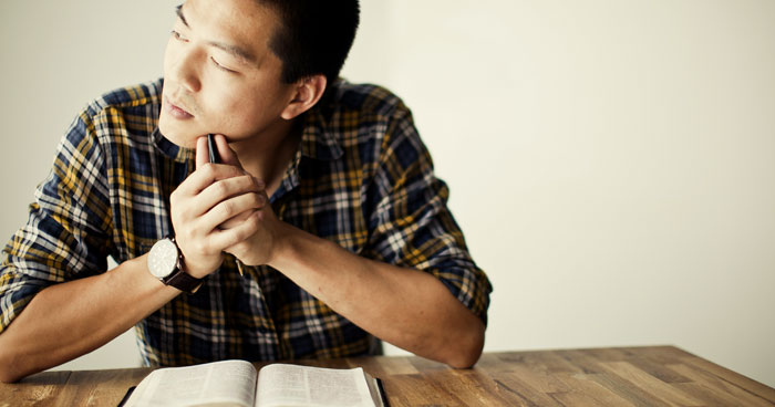 Picture of man reading the Bible and thinking