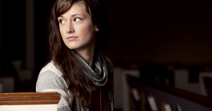 Picture of young woman sitting in church