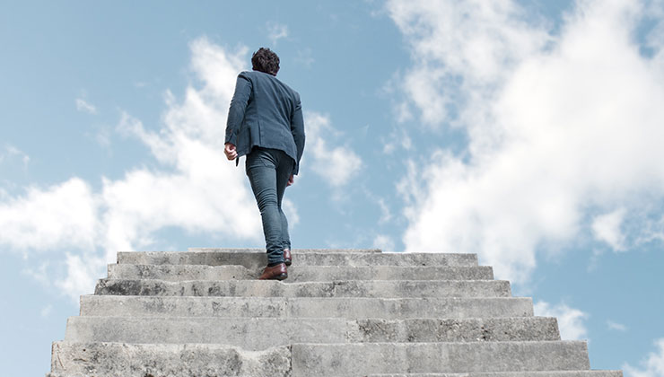 man climbing stairs to heaven